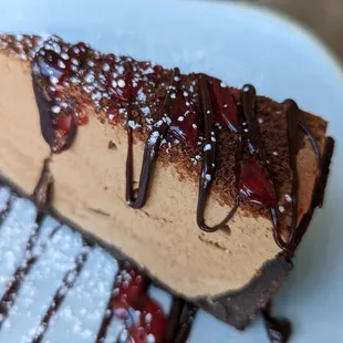 Chocolate Cheesecake with chocolate and raspberry drizzle