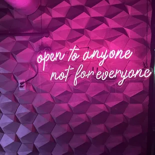 a neon sign that says open to anyone not for everyone