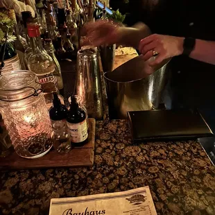 a bartender mixing a drink at a bar