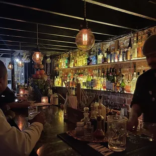 a bar with people sitting at the bar