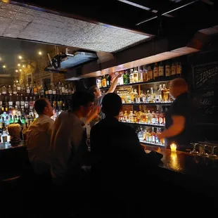a group of people sitting at a bar