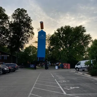 a blue tower in a parking lot