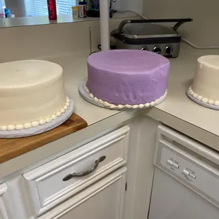 three cakes on a countertop