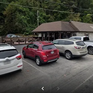 a parking lot with cars parked in front of it