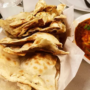 a plate of pita chips and a bowl of soup