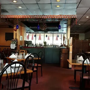 a dining area with tables and chairs