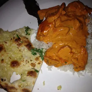 Butter chicken with rice and garlic naan can you spot the "heart" click like if you do