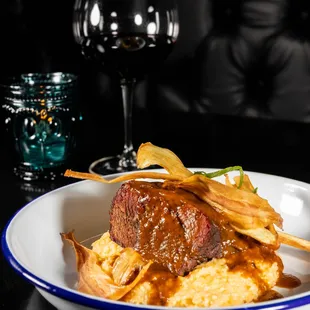 Braised Short Rib - 
Aged cheddar &amp; black pepper grits, crispy parsnips, bordelaise sauce.
