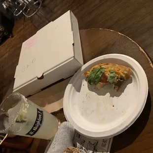a half eaten pizza and a drink