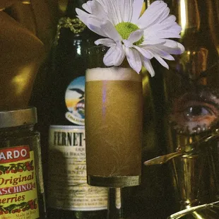 a flower in a cocktail glass