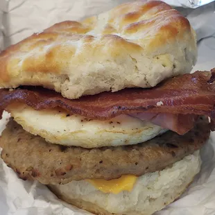 Egg, sausage, ham, bacon, and cheese on a biscuit