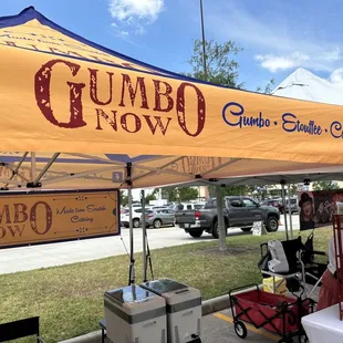 a man standing under a tent