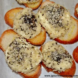 a close up of a tray of bread with cheese on it