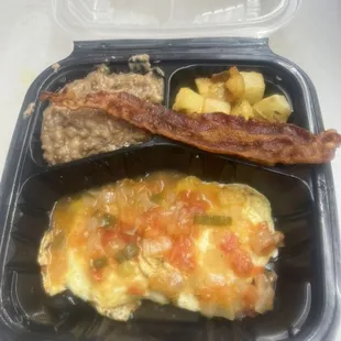 Huevos Rancheros with bacon, beans and potatoes