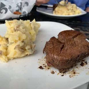 a steak and mashed potatoes on a plate