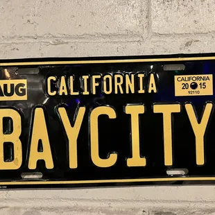 a california license plate mounted on a brick wall