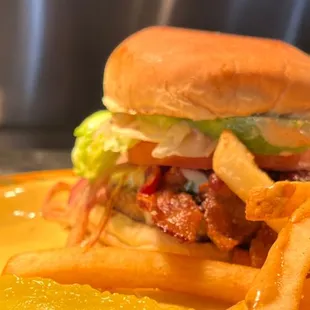 a burger and fries on a yellow plate