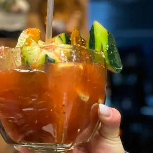 a person holding a bloody drink