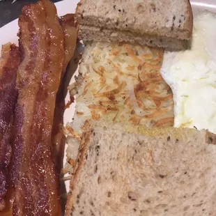 Three eggs over medium with hash browns and add bacon.