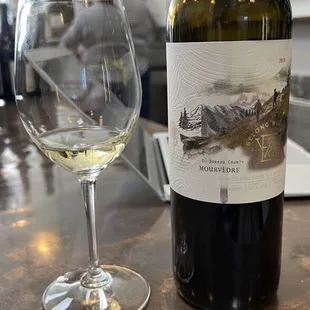 a bottle of wine and a glass of wine