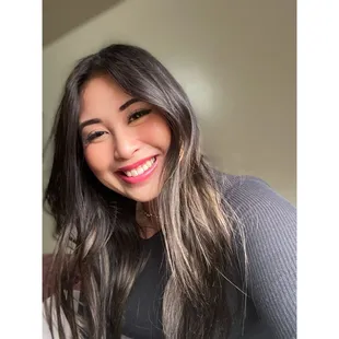 a smiling woman with long hair