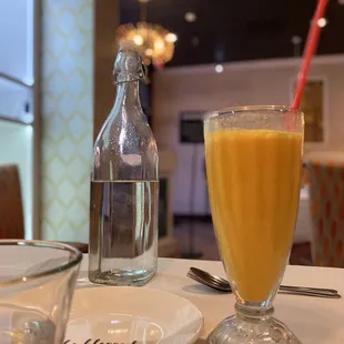 Mango lassi and cold water brought to the table.