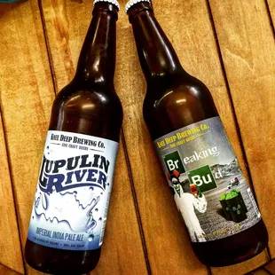 two bottles of beer on a wooden table