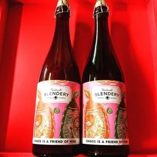 two bottles of beer on a red background