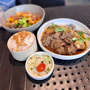three bowls of food on a table