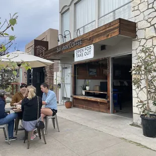 people sitting at tables outside