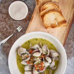 Steamed clams in a garlic and white wine, cilantro broth. PERFECT for dipping the crusty bread!