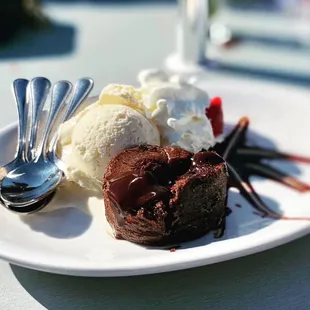 a chocolate dessert with ice cream and strawberries
