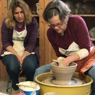 A student looks on while instructor Elizabeth Krome demonstrates throwing techniques.