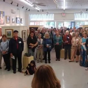 The judge speaks to the crowd at the 2016 Art Speaks on the Bay statewide juried art show opening reception.