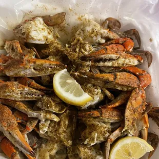 a pile of crab legs with a slice of lemon