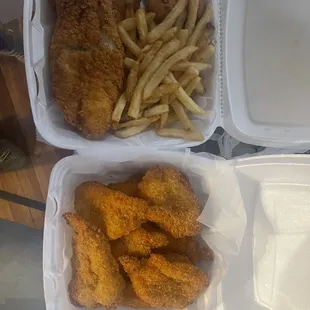 two trays of fried chicken and french fries