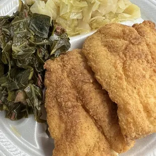 Two piece catfish with greens and cabbage.