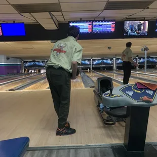 a man standing at the end of a bowling alley