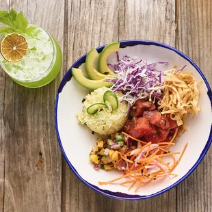 Tuna poke bowl with steamed rice, pineapple &amp; mango pico, shaved jalapeños, avocado, cabbage slaw, poke vinaigrette, wonton frizzle