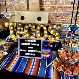 Beautiful salsa bar with sliced watermelon tower