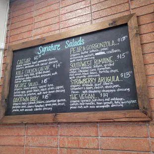 a menu on a brick wall