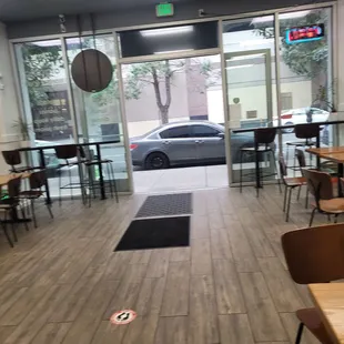a view of a restaurant with tables and chairs