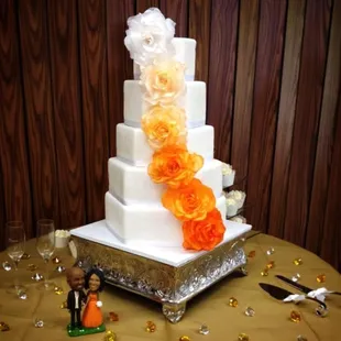 My wedding cake, 5 layer hexagon-custom silk flowers: lemon, white w/ fresh strawberries, orange velvet, butter pecan, chocolate