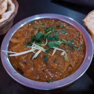 a bowl of chili and naan bread