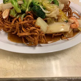 Seafood tender greens over egg noodles