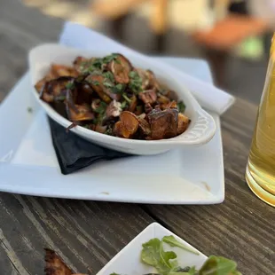 a plate of food and a glass of beer