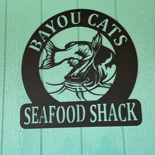 a sign for bayou cats seafood shack