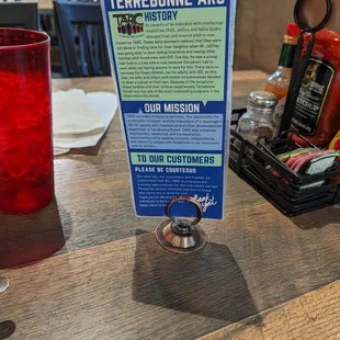 a menu and a glass of red wine