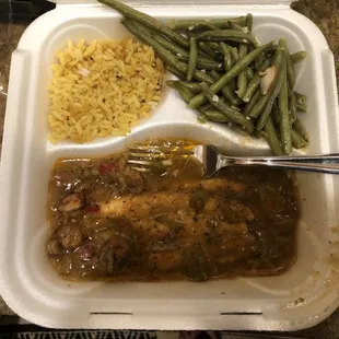 Catfish in crawfish étouffée With yellow rice and green being almandine.