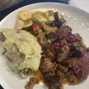 Meatloaf with mashed potatoes and mixed vegetables.